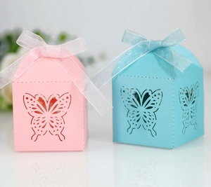 Detail of laser-cut butterfly hollow candy boxes with elegant organza ribbons and bows