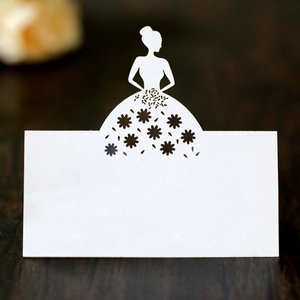 Detail of laser-cut white table card featuring an elegant girl silhouette and floral pattern