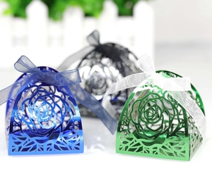 Detail of laser-cut rose gift boxes in blue, green, and silver with chiffon ribbons