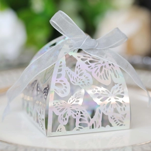 Macro view of laser-cut butterfly hollow candy box with iridescent silver holographic finish