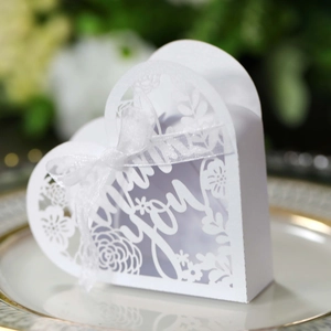 Detail of laser-cut heart favor box with Thank You text and white ribbon bow
