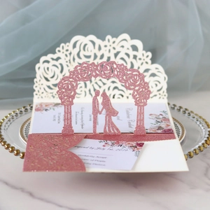 Laser cut rose gold glitter wedding invitation with 3D floral arch and couple silhouette