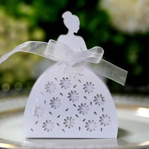 Close-up of elegant white bridal silhouette candy box with laser-cut hollow floral patterns
