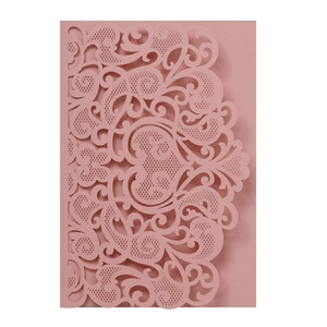 Detailed laser-cut pattern on dusty pink pearlized paper wedding invitation cover