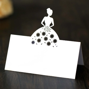 Detailed laser-cut white wedding place card featuring elegant bridal silhouette and floral hollow pattern