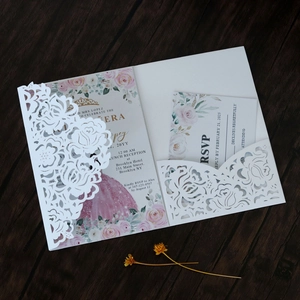 Detail of laser-cut floral invitation with white lace shell and RSVP card insert