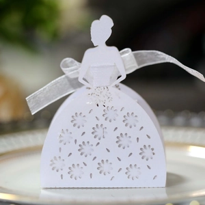 Detail view of white laser-cut bride dress candy box with floral patterns and silk ribbon