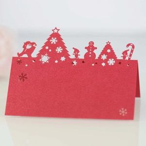 Detail view of laser-cut red Christmas place card with Santa and reindeer motifs