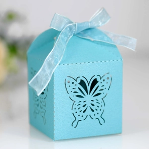 Detail of laser-cut butterfly favor box in sky blue with a satin ribbon bow tie