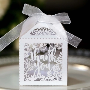 Macro shot of laser cut white thank you gift box with floral pattern and ribbon