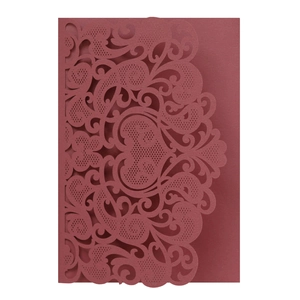 Detailed laser-cut burgundy invitation cover with European patterns and heart shape