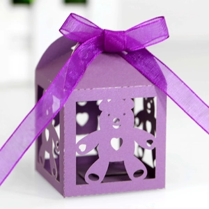 Close-up of purple laser-cut bear candy box with heart detail and organza ribbon