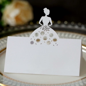 Detail of white laser-cut wedding name card with silhouette and floral hollow design