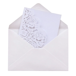 Detailed laser-cut rose pattern on white wedding invitation card with matching envelope