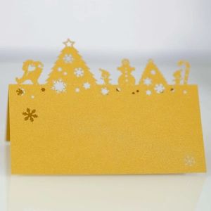 Detailed laser-cut Christmas tree and snowman silhouette on golden pearlescent place card