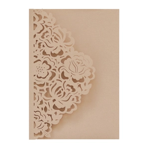 Macro view of laser-cut floral pattern on brown kraft paper wedding invitation cover