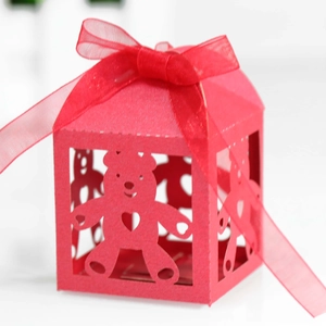 Detail showing the red laser-cut teddy bear gift box with a sheer organza ribbon bow