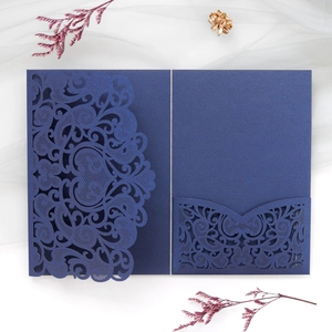 Detail of navy blue laser-cut floral invitation cover with elegant pearlescent paper finish