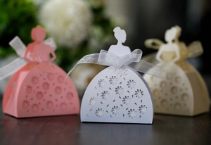 Detailed laser-cut candy boxes featuring elegant female silhouettes and ribbon bows