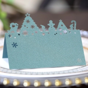 Close-up of laser-cut Christmas place card with reindeer and snowflake details