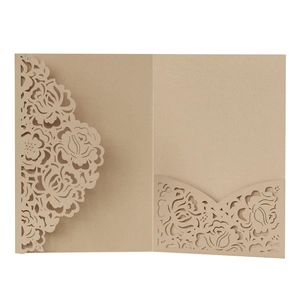 Detail view of laser-cut floral patterns on kraft paper wedding invitation cards