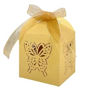 Detail of laser-cut butterfly pattern on golden pearlescent paper wedding gift box