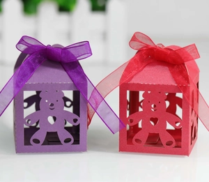 Detail of purple and red teddy bear hollow-out candy boxes with sheer organza ribbons