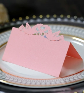 Detailed laser-cut pink place card featuring a romantic birds and heart hollow design