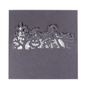 Detailed laser cut Halloween place card featuring witch, pumpkin and haunted house silhouette