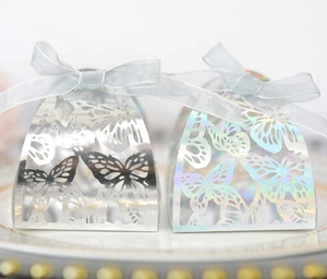 Detailed view of laser-cut butterfly gift boxes in silver mirror and holographic finishes
