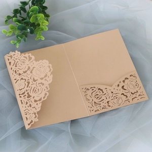 Close-up detail of laser-cut rose floral design on brown kraft wedding invitation card
