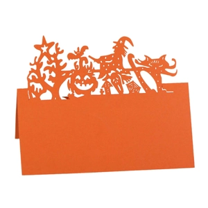 Laser-cut orange Halloween place card featuring witch, pumpkin, and bat cutout silhouettes