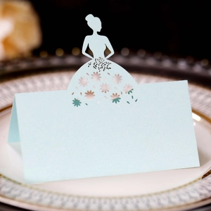 Detail of light blue laser cut place card with elegant female silhouette and floral pattern