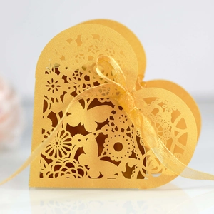 Golden laser cut heart gift boxes with butterfly patterns and ribbon for weddings