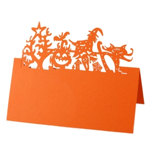 Detail of orange Halloween place card with laser-cut pumpkin and witch motifs
