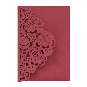 Detailed laser-cut rose pattern on burgundy cardstock for premium wedding invitations