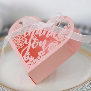 Detail of pink laser-cut heart candy box with Thank You text and white silk ribbon
