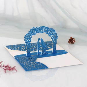 Detail of 3D royal blue laser cut wedding invitation with glitter rose arch and couple