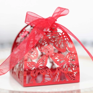 Detailed close-up of a red laser-cut butterfly gift box with a silk ribbon bow