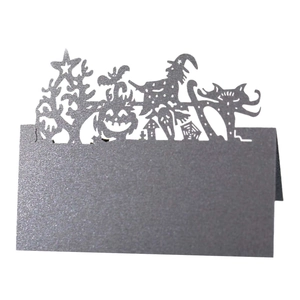Laser-cut black cardstock place card with detailed Halloween silhouette and glitter finish