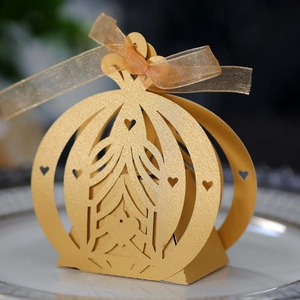 Detailed view of champagne gold carriage gift box with laser-cut lace and ribbon bow