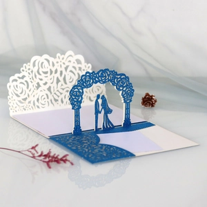 Detail of 3D pop-up wedding card featuring laser-cut roses and blue glitter archway