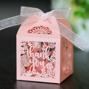 Detailed view of pink laser-cut gift box with thank you text and silver ribbon