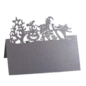 Intricate laser-cut Halloween place card featuring a witch, pumpkin, and cat silhouette