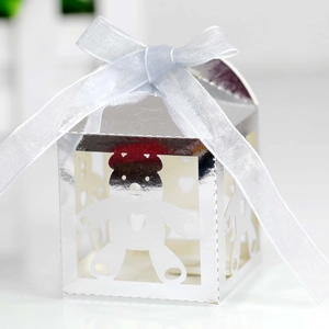 Close-up of hollow bear silver gift box with light blue ribbon and mirror finish surface
