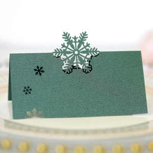 Détail du marque-place de Noël vert foncé avec flocon de neige découpé au laser