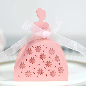 Detail of pink laser-cut princess candy box with elegant floral hollow patterns and white ribbon