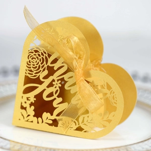 Detailed laser-cut 'Thank You' gold heart favor box with floral pattern and ribbon