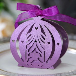 Detailed laser-cut heart patterns on dark purple favor box with shiny pearlescent finish