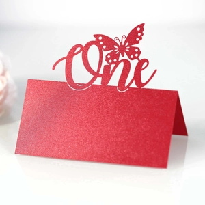 Detail of red glitter cardstock butterfly seat card with hollow One design for party
